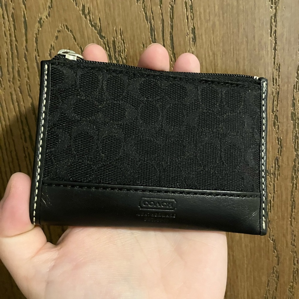 This is a Coach keychain wallet with a zipper and back pocket.
